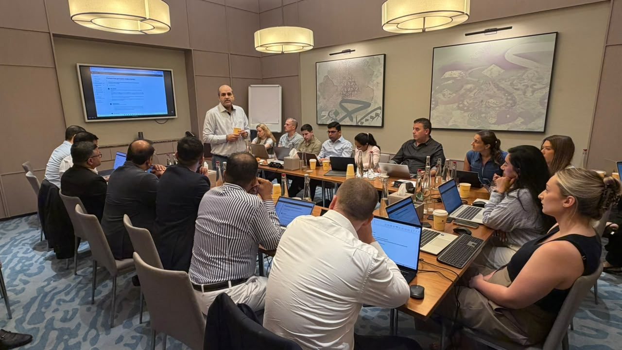 Zaid Aboobaker, AIFC trainer, leading a hands-on Claude for Finance workshop for around twenty finance professionals at The Academy, Address Beach Resort, Dubai